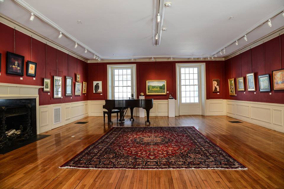 Art gallery with fireplace and piano