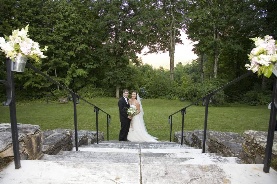 Couple posing at bottom of stairs