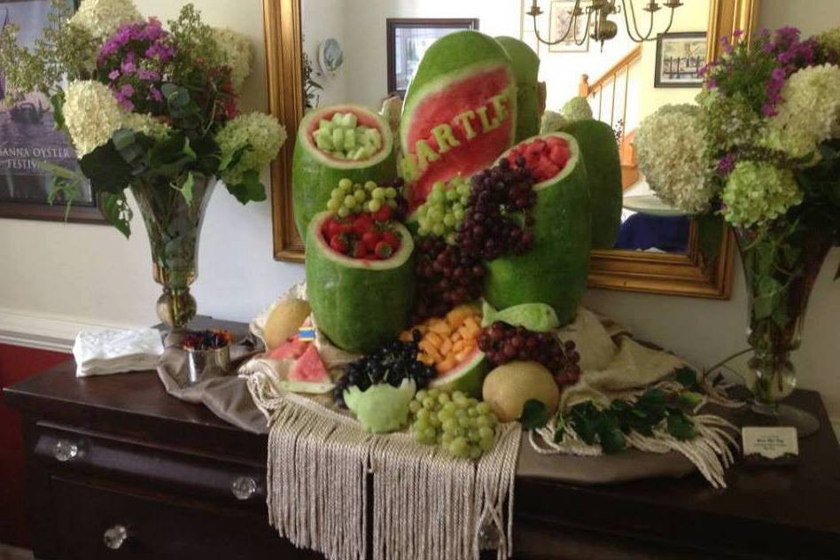 watermelon carved for a memorial service, with fruit cascading down in the other melon bowls.. was a great hit