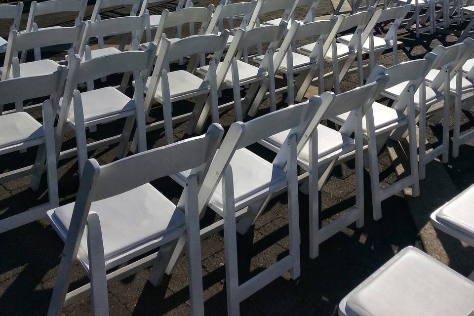 Our white wood chairs set up for a ceremony