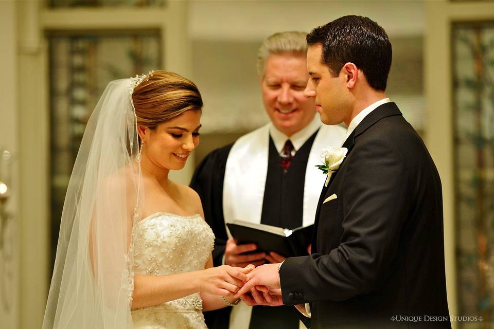 Putting the ring on her groom