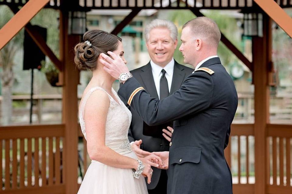 Groom wipes his bride's tears