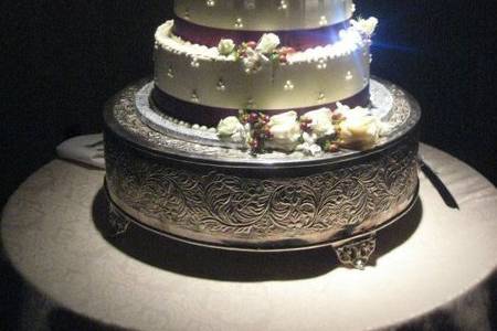 Beautiful cake display accented with lights and flowers.