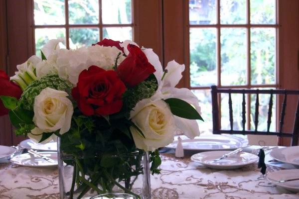 cube centerpiece of red & white roses and white lilies