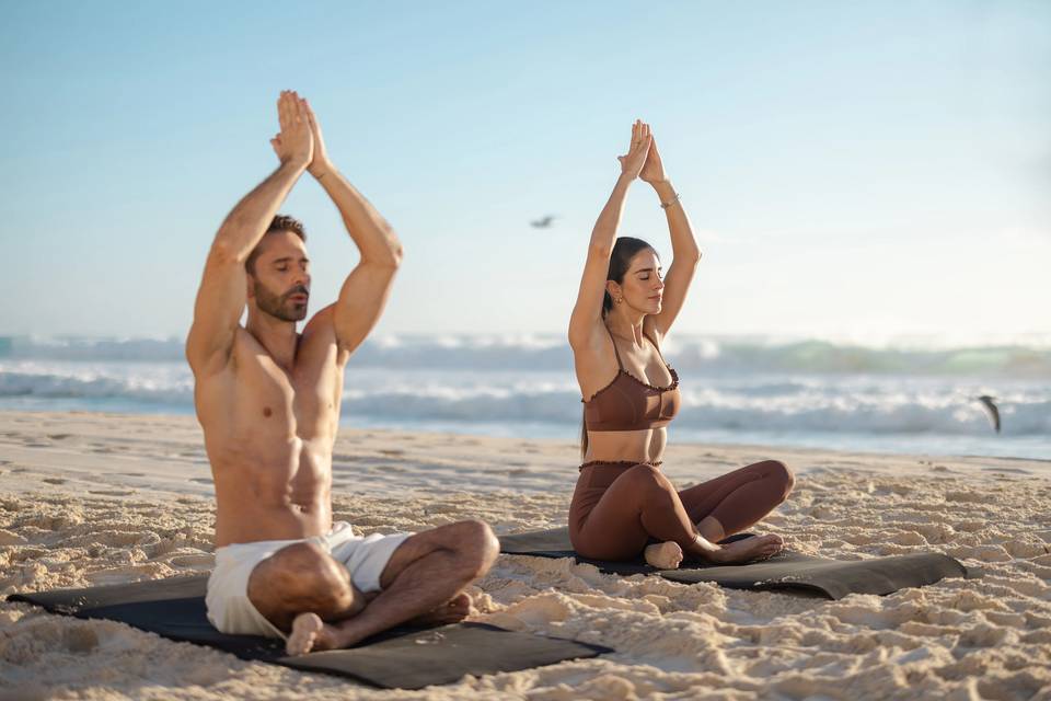 Couples beach yoga