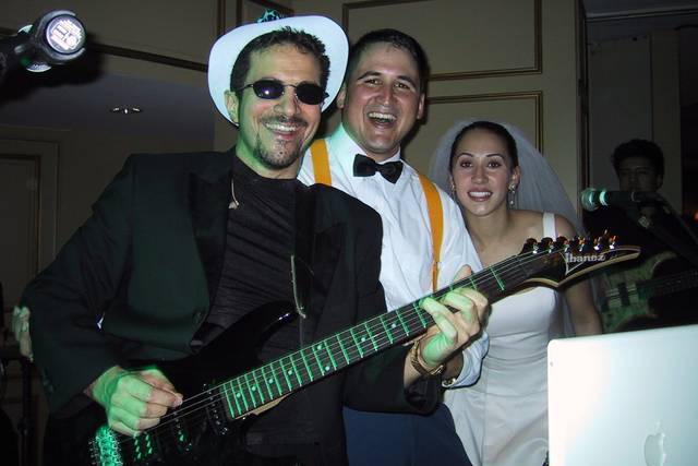 Bride and groom singing with the band