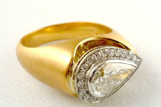 Pear shape diamond in platinum over 18k yellow gold.