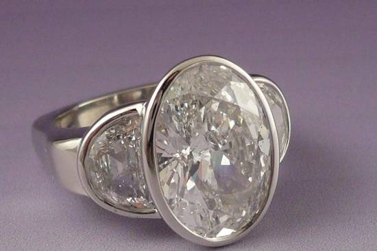 5 carat diamond with half moon sides in platinum.