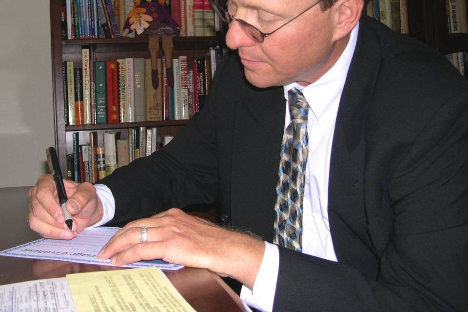 Bob signing his very first marriage license in 2004