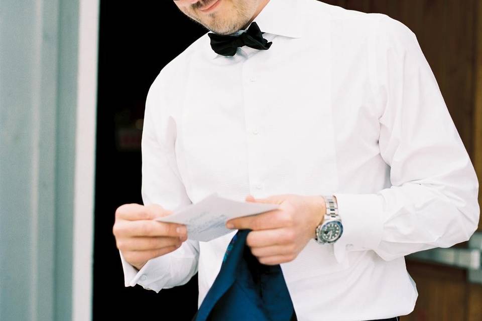 Groom reading letter from brid