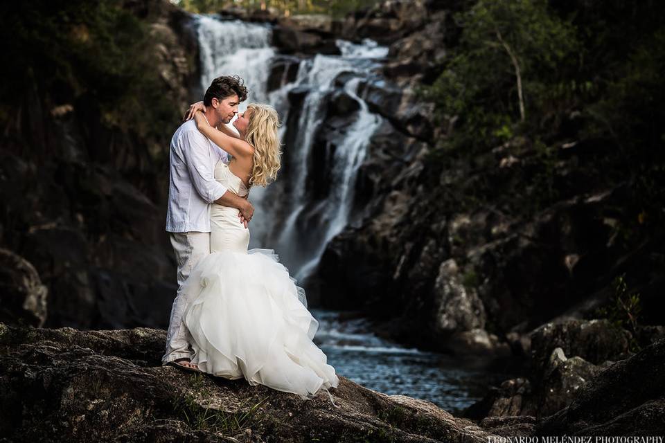 Couple by a waterfall on the day after the wedding