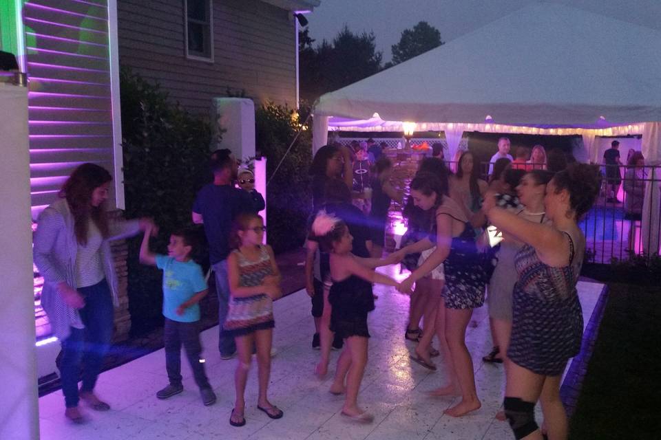 Outdoor party. We supplied tent over pool, White dance floor and unlighted house and yard with DJ Setup 5.