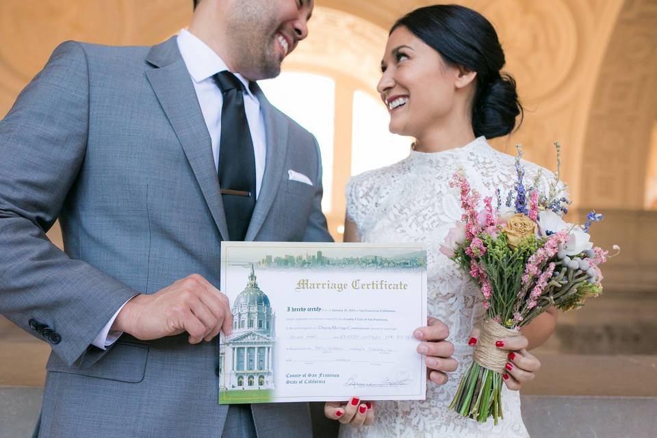 Bride and groom holding their certificate