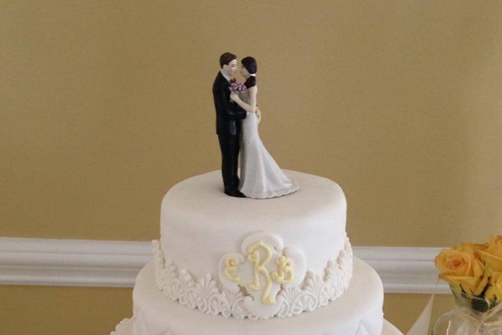 All white wedding cake with figurines