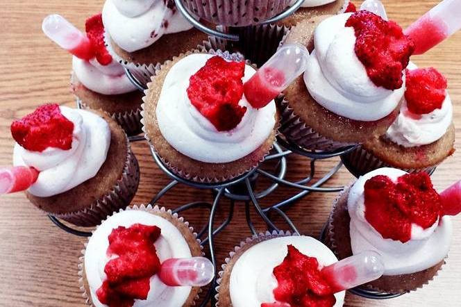 Strawberry cupcakes, with whipped cream topping, strawberry puree and a pipette of strawberry sauce