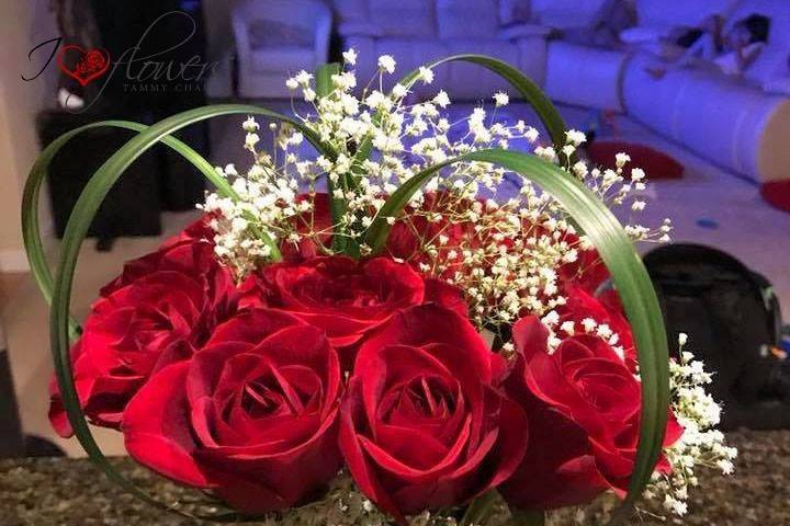 Roses, babybreath, and heart shape accent centerpiece