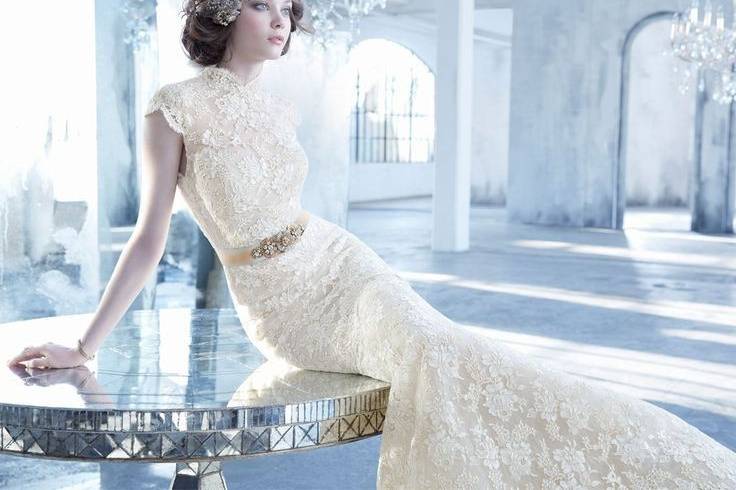 Style LZ3352<br>
Ivory/Gold alencon lace trumpet bridal gown with cashmere chiffon underlay, mandarin collar neckline, keyhole back, Maria Elena floral crystal belt at natural waist, circular skirt, chapel train.
<br>Available in Ivory Gold or Ivory<br>
Belt available in Gold or Silver
