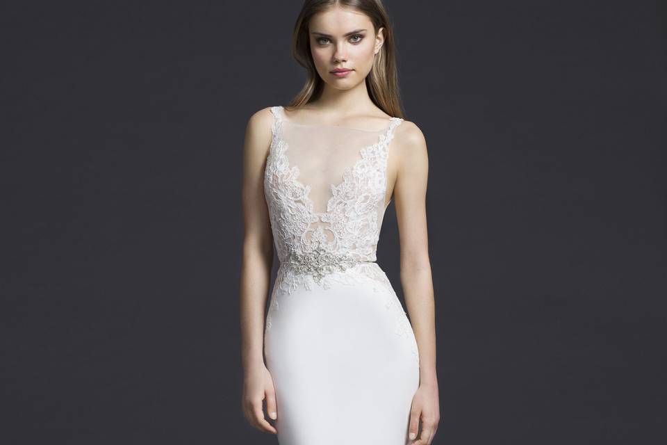 3655	Ivory crepe trumpet gown, sparkle net illusion V neckline, shear Alencon lace appliqued bodice with keyhole back, crystal motif at natural waist, sheer lace cutouts at hip and hemline, chapel train.
