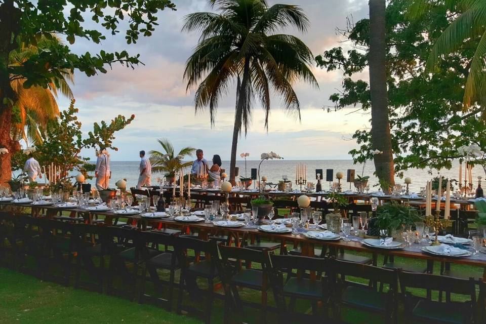 Wedding reception outdoors by the water. Rustic elegant look.