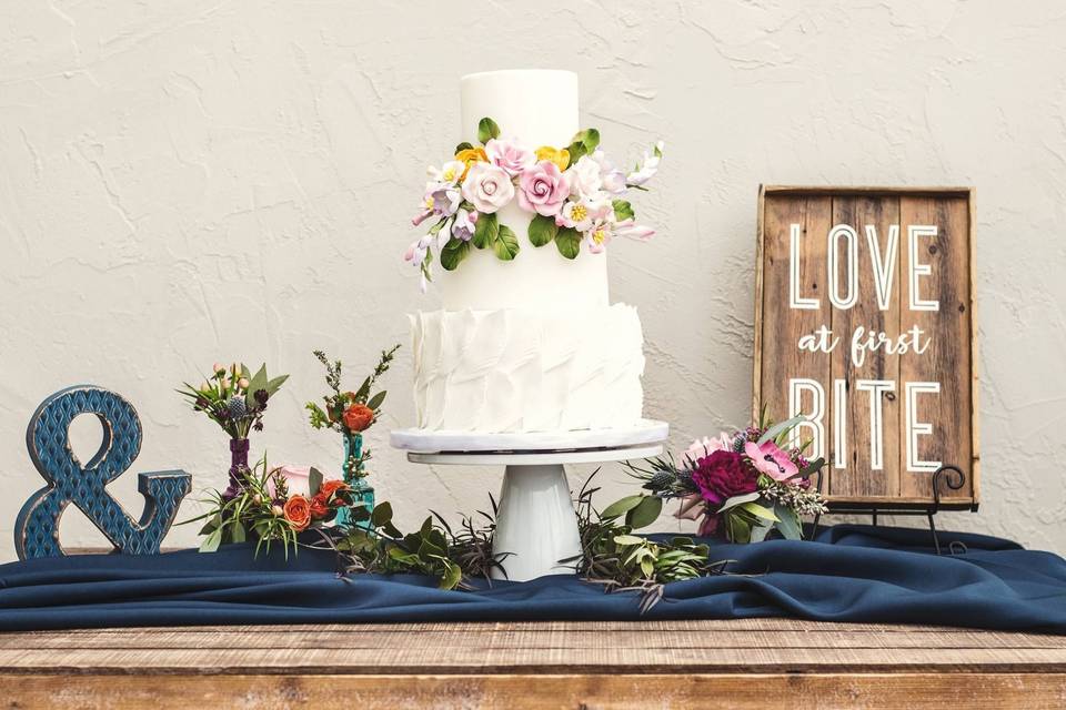 Fondant feather and flower wedding cake
