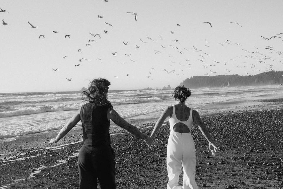 Brides running on the beach