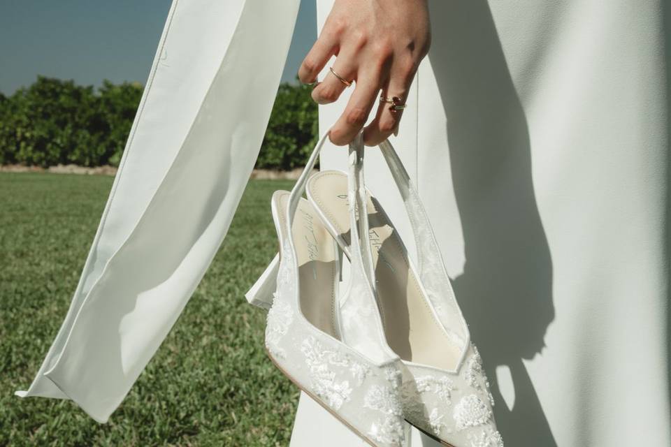 Bride holding her shoes