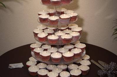 Cupcakes are an easy mess free way to serve cake! Red velvet cupcakes with buttercream icing and custom mini wedding cake on top.