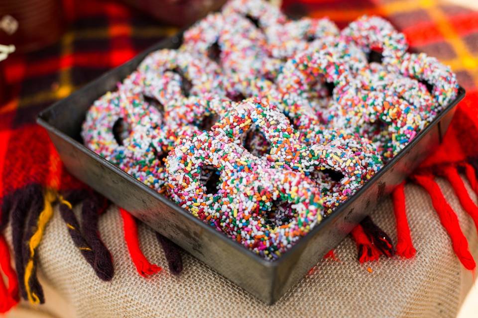 This is an example of the variety of candy and sweets we provide and could provide you for a candy buffet at your wedding or event.
Sweet City Candy provided the Chocolate Covered Pretzels with Rainbow Sprinkles for this rustic event.