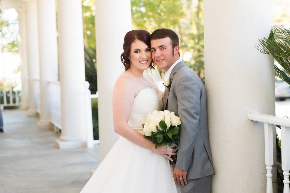 Couple posing against column