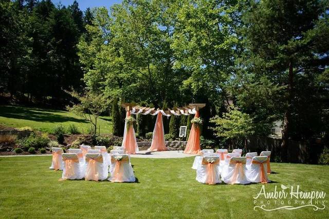 Outdoor wedding setup with decorated arbor