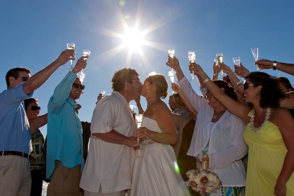 bride and groom toast to their new life together with family and friends at a Captiva Island beach wedding