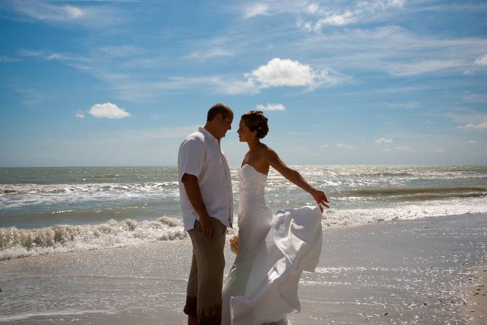 Wedding couple pose on the beach at their Sanibel Island wedding