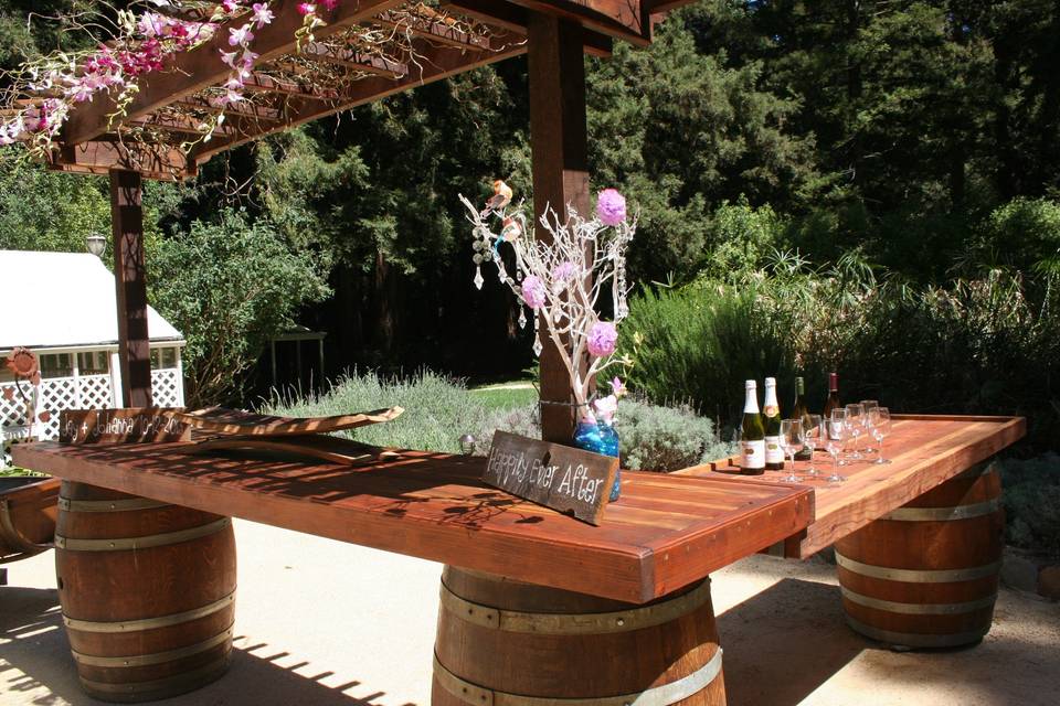 Beautiful wine barrel arbor bar makes a wonderful gathering spot for your guest. Great for bartenders or a dessert bar too!
