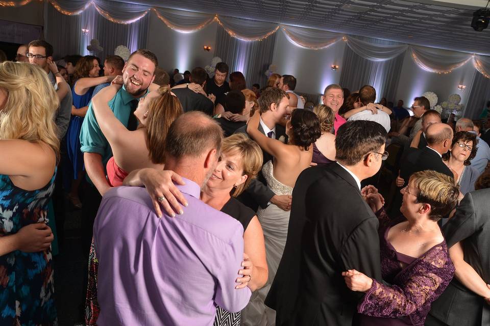 Couple dancing with guests