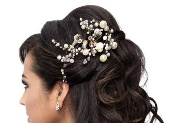 Half updo wavy hair with flower hair ornament