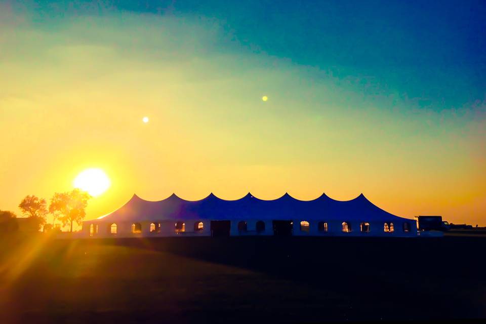 Sunset behind an event rental tent