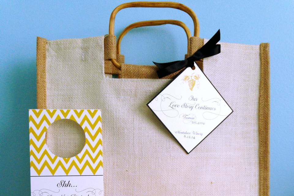 Guest Welcome Bag by Poetic Twist shown with Door Hanger, Welcome Note, Agenda, Custom Water Bottles, Chevron Print Straws