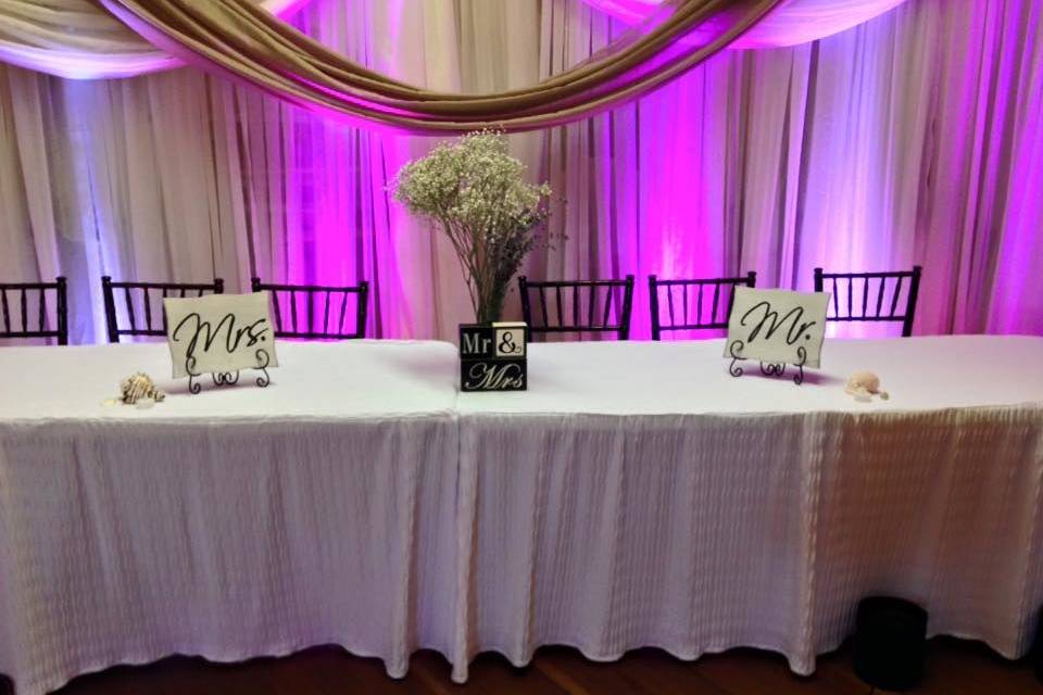 Reception table and pink uplighting