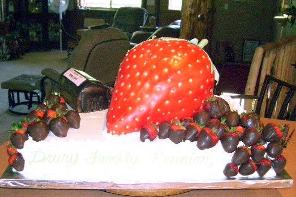 large strawberry cake with chocolate dipped strawberries