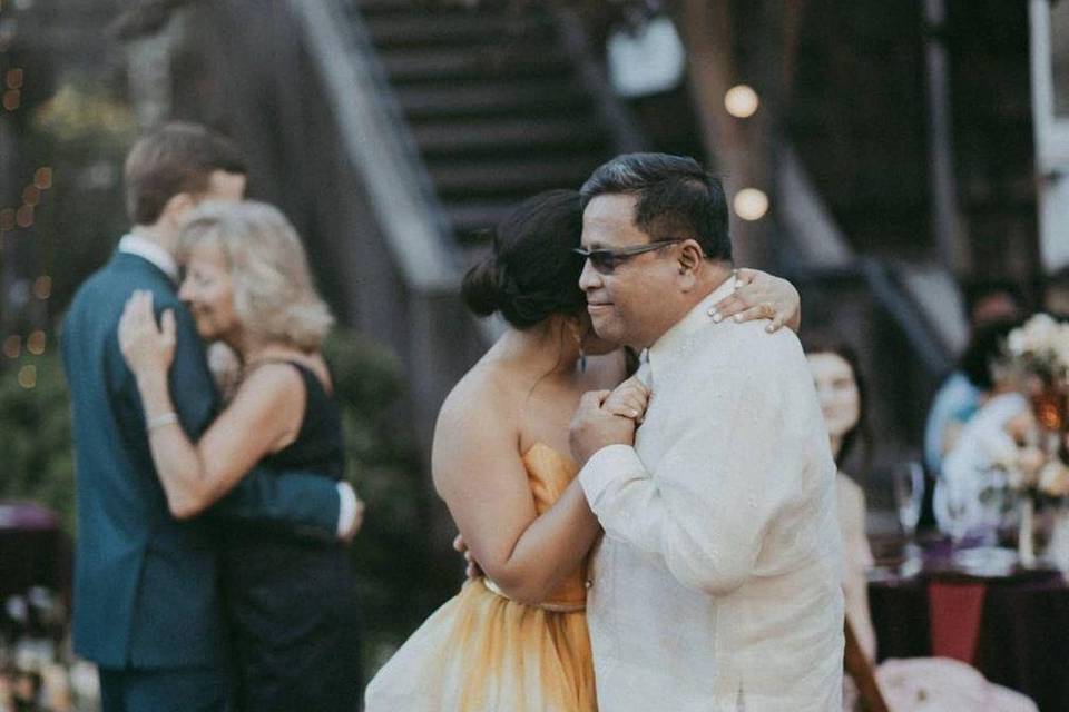 Couples dancing in courtyard