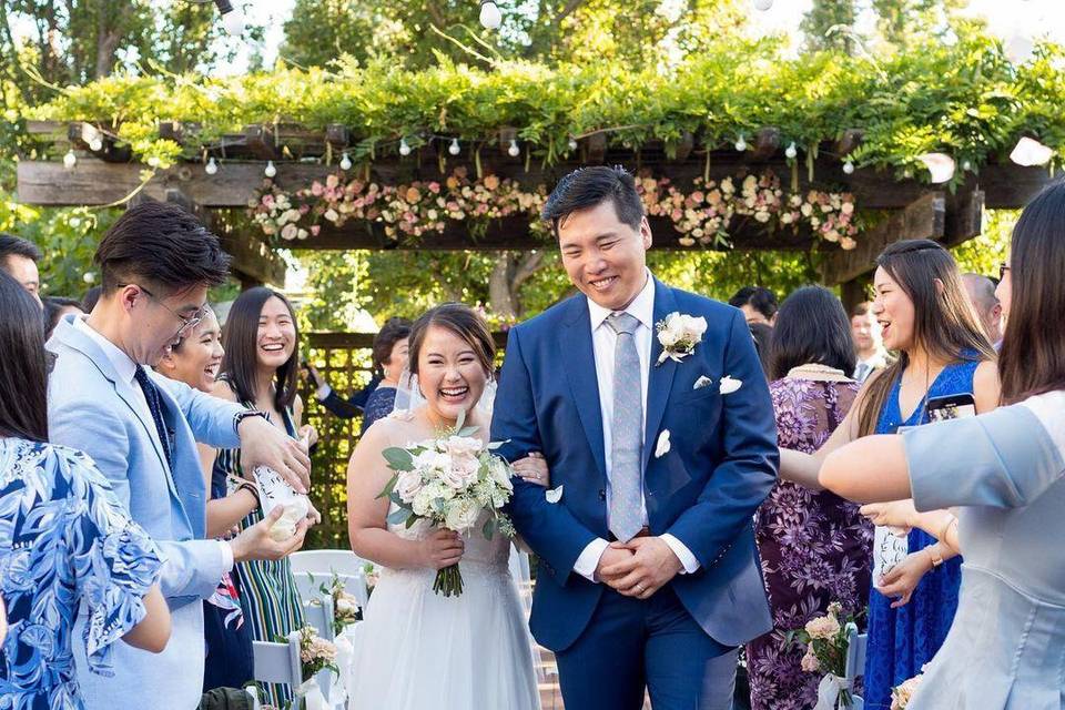 Couple coming down the aisle