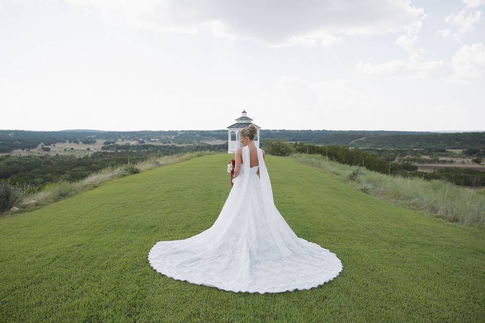 Bride on lawn near gazebo