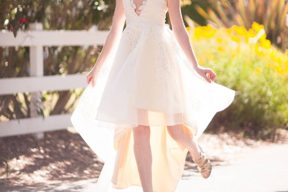 Fun high-low wedding dress with a very low neckline. French lace detail over silk organza.