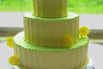 Created to match the bride's wedding invitation, this delicious creation is accented with hand-made yellow sugar daisies.