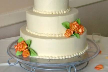 Clean, classic design with accents of hand-made & painted sugar roses.
