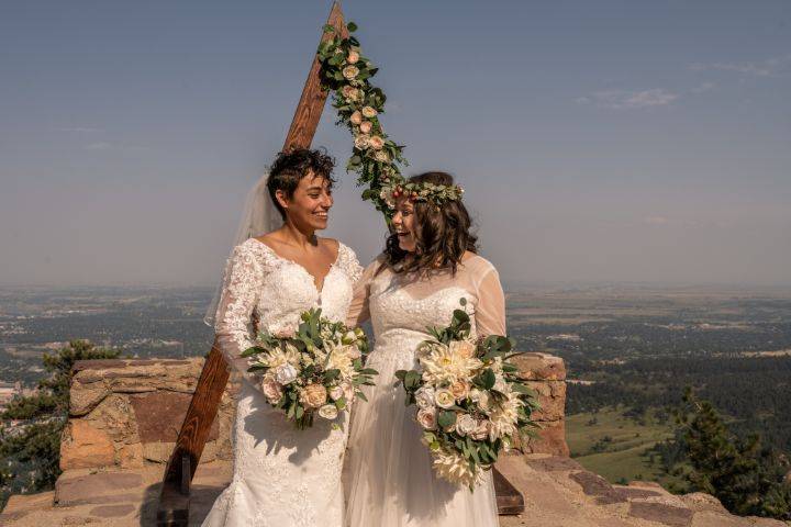 Two brides in front of arch