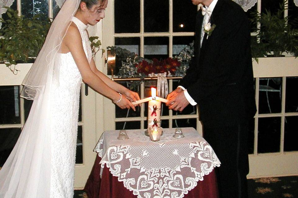 Sharing a common flame, lighting the unity candle.