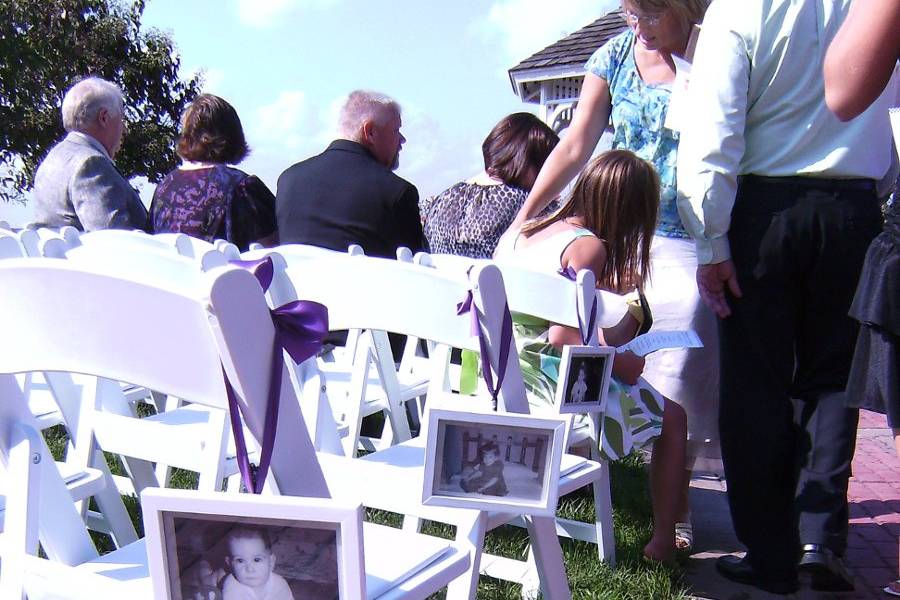 Outdoor ceremony with photos on chairs