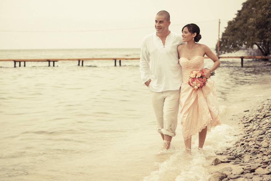 Wedding couple walking at the beach