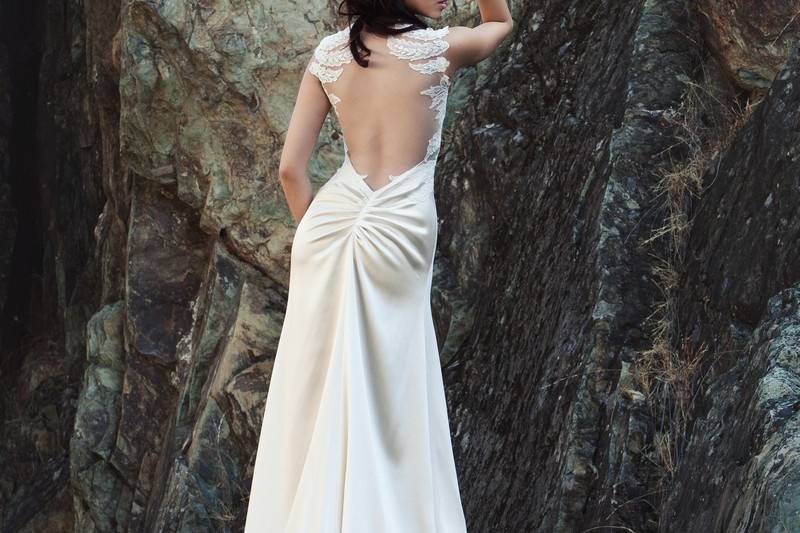 Spring 2014 AnalieseCrepe-back silk satin minimal trumpet gown with a sheer inset low back. It has symmetrical re-embroidered French Alençon lace appliques at back feathering down the sides and under the draped cowl neckline.